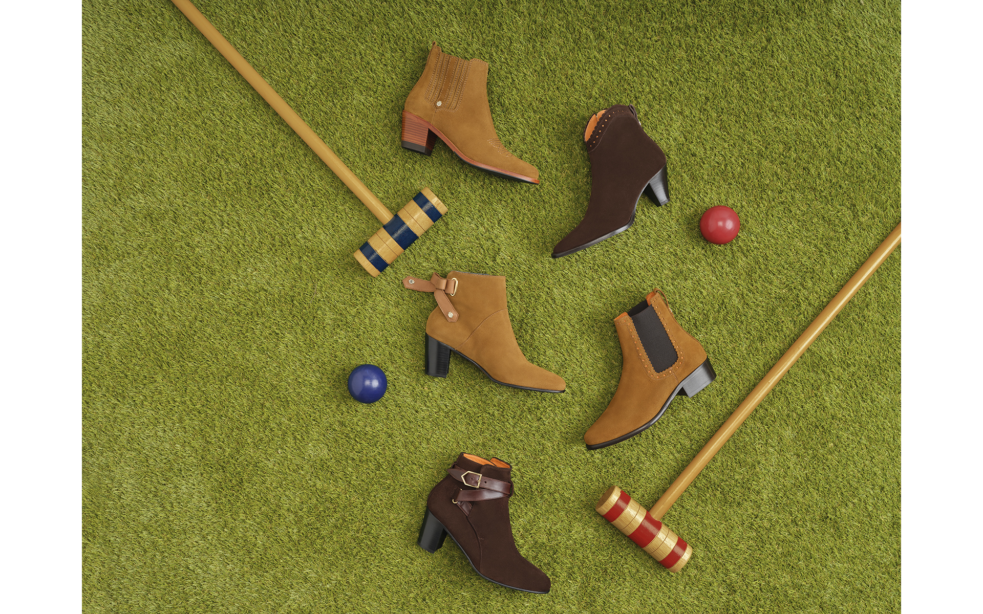 Summer photo shoot shoes sitting on grass with a croquet stick as flat lay brand photo shoot